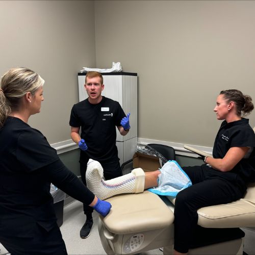 medical team discussing total contact casting with a patient