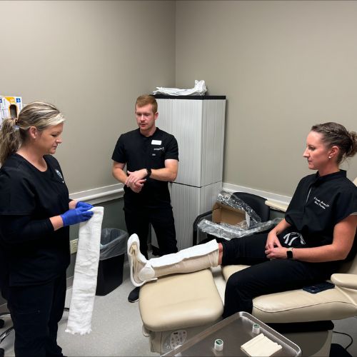 doctors applying a total contact cast to a patient