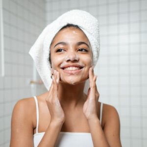 young woman washing her face