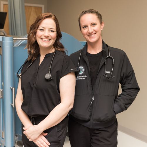 Heather Hutchings, M.D., and Camlin Morton, FNP, standing next to each other 